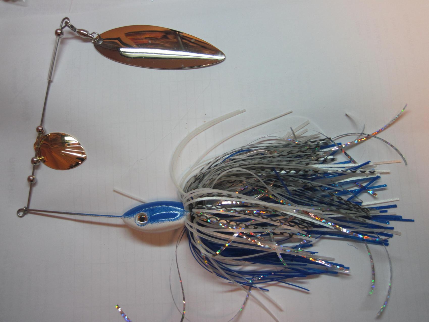 2 1/2 oz. this was my vision of what I wanted to make for stripers, .040blades,.051gauge wire,8/0 hooks, doubled skirts, Total wgt. 3oz.plus!